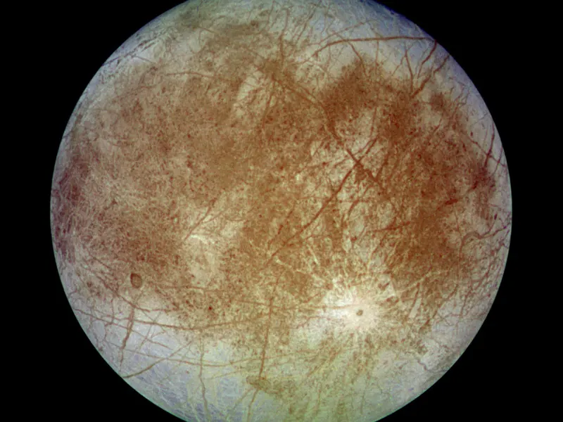 A pale, icy moon criss-crossed with long brown cracks