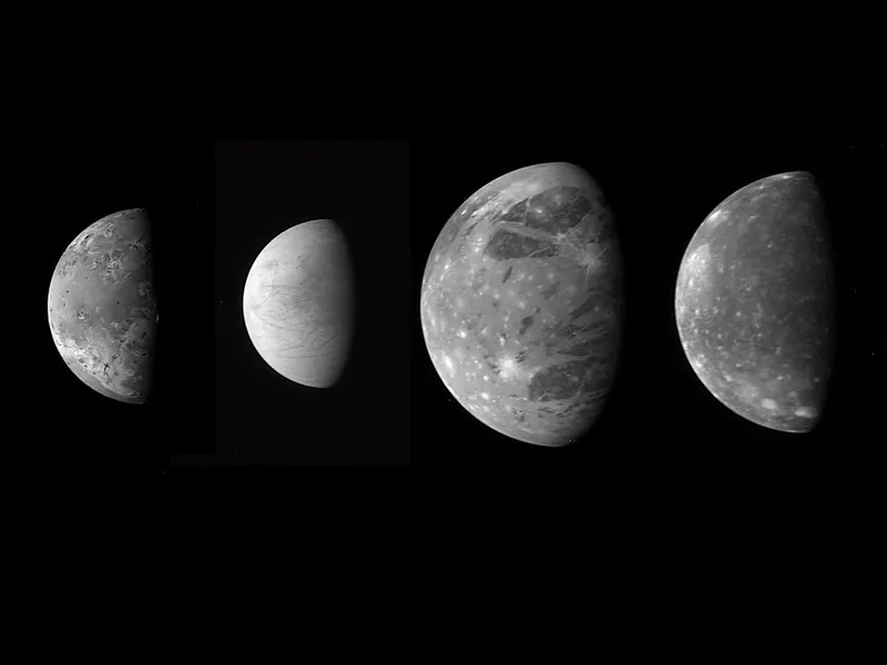 Four moons side by side: yellow Io, white Europa, grey-brown Ganymede and dark Callisto