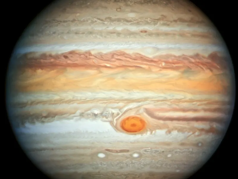 Jupiter: a huge striped ball in cream, orange and brown bands, with the Great Red Spot on its lower half