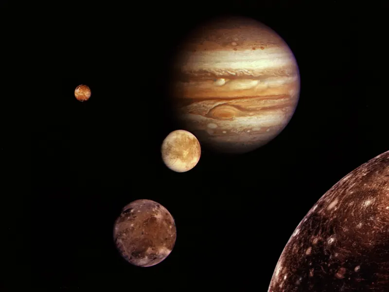 Jupiter with its four big moons arranged in front of it in a collage